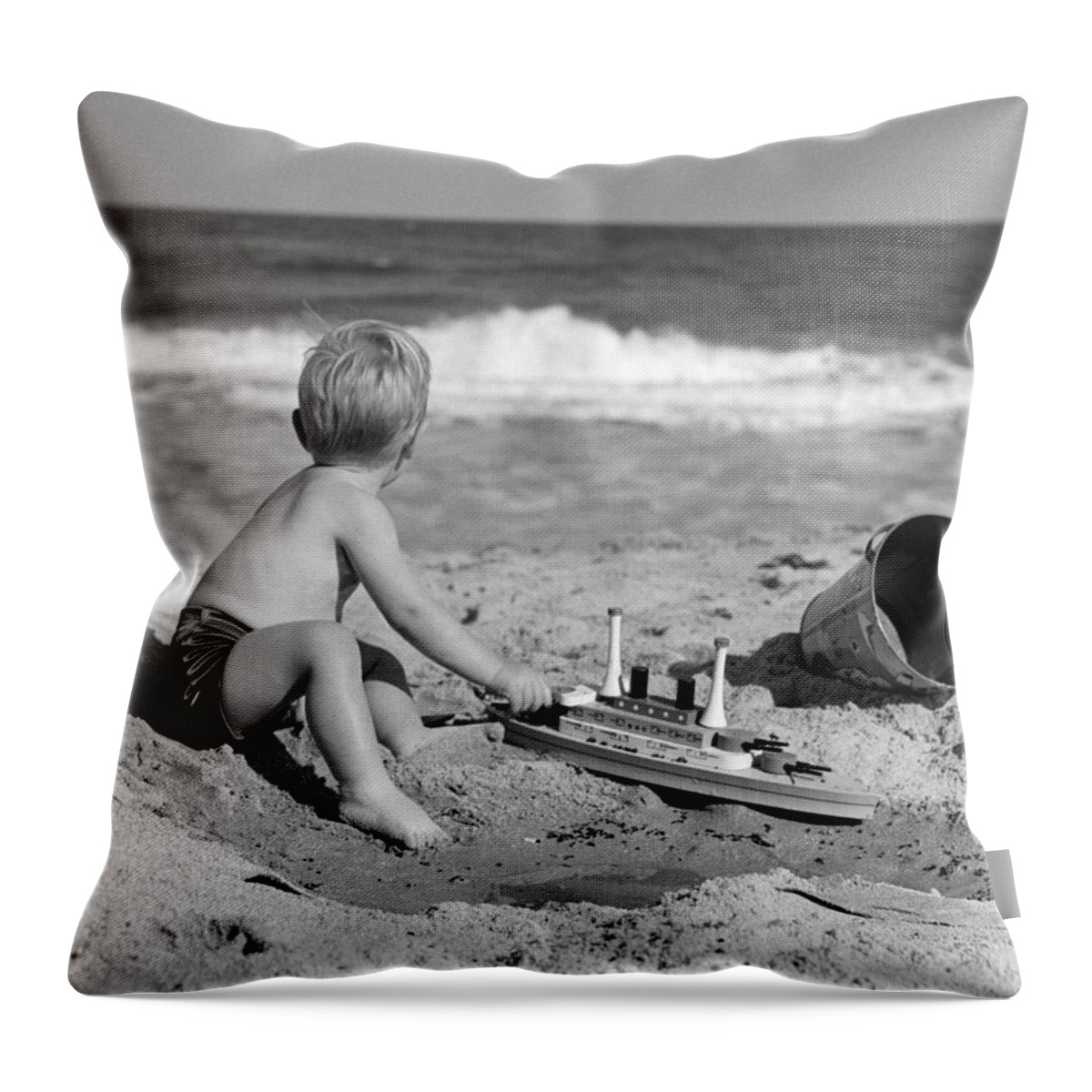 1950s Throw Pillow featuring the photograph Boy Playing At The Beach, C.1950s by H Armstrong Roberts and ClassicStock