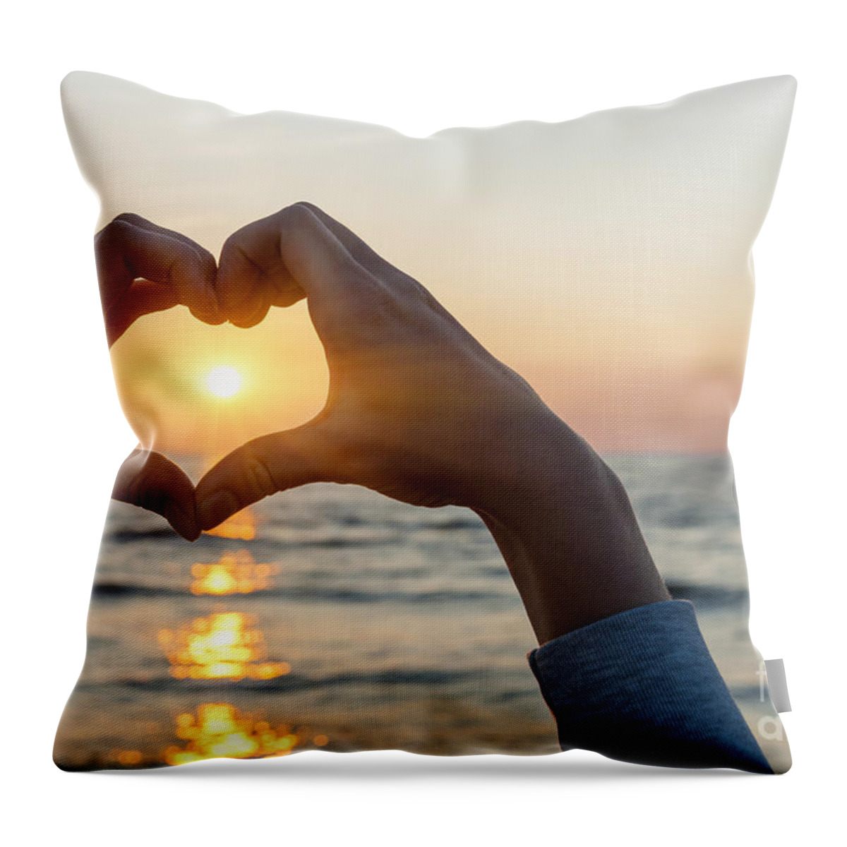 Heart Throw Pillow featuring the photograph Heart shaped hands framing ocean sunset by Elena Elisseeva