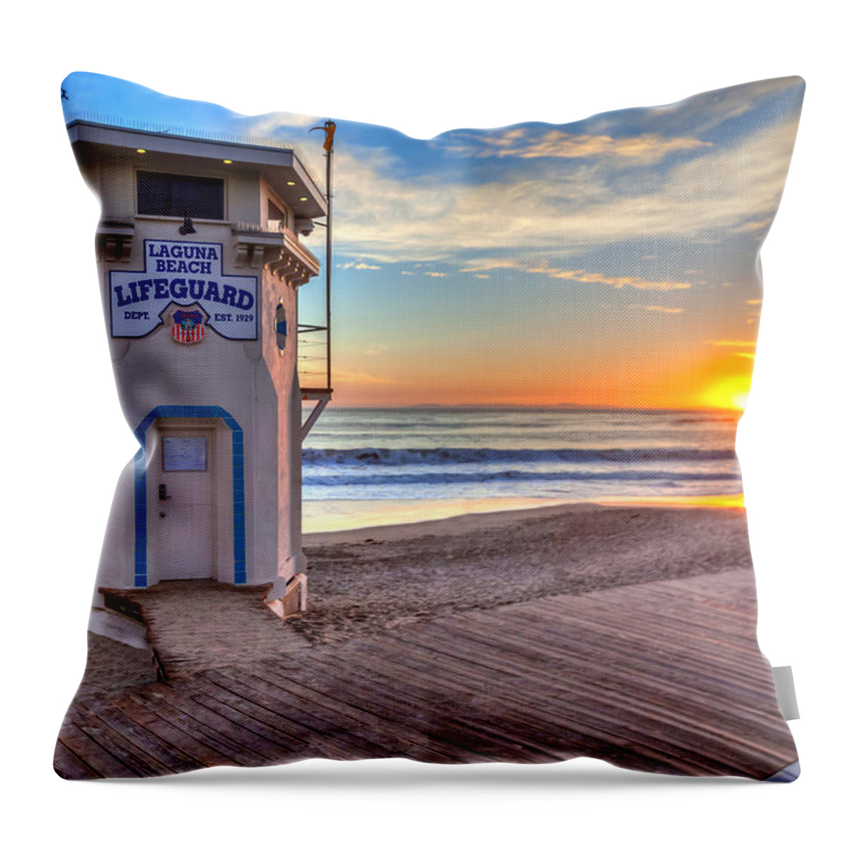 Laguna Beach; Lifeguard; Tower; Sunset; Waves; Surf; Village; Town; Buildings; Boardwalk; Beach; Shore; Sand; Summer; Resort; Famous; Architecure; Historic; Icon; Sunburst; Bright; Orange; Glow Throw Pillow featuring the photograph Lifeguard Tower on Main Beach by Cliff Wassmann