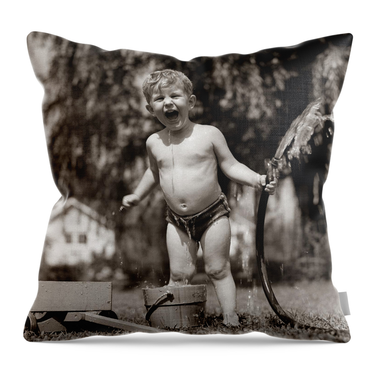 1940s Throw Pillow featuring the photograph Little Boy Playing With Hose, C.1940-50s by H. Armstrong Roberts/ClassicStock