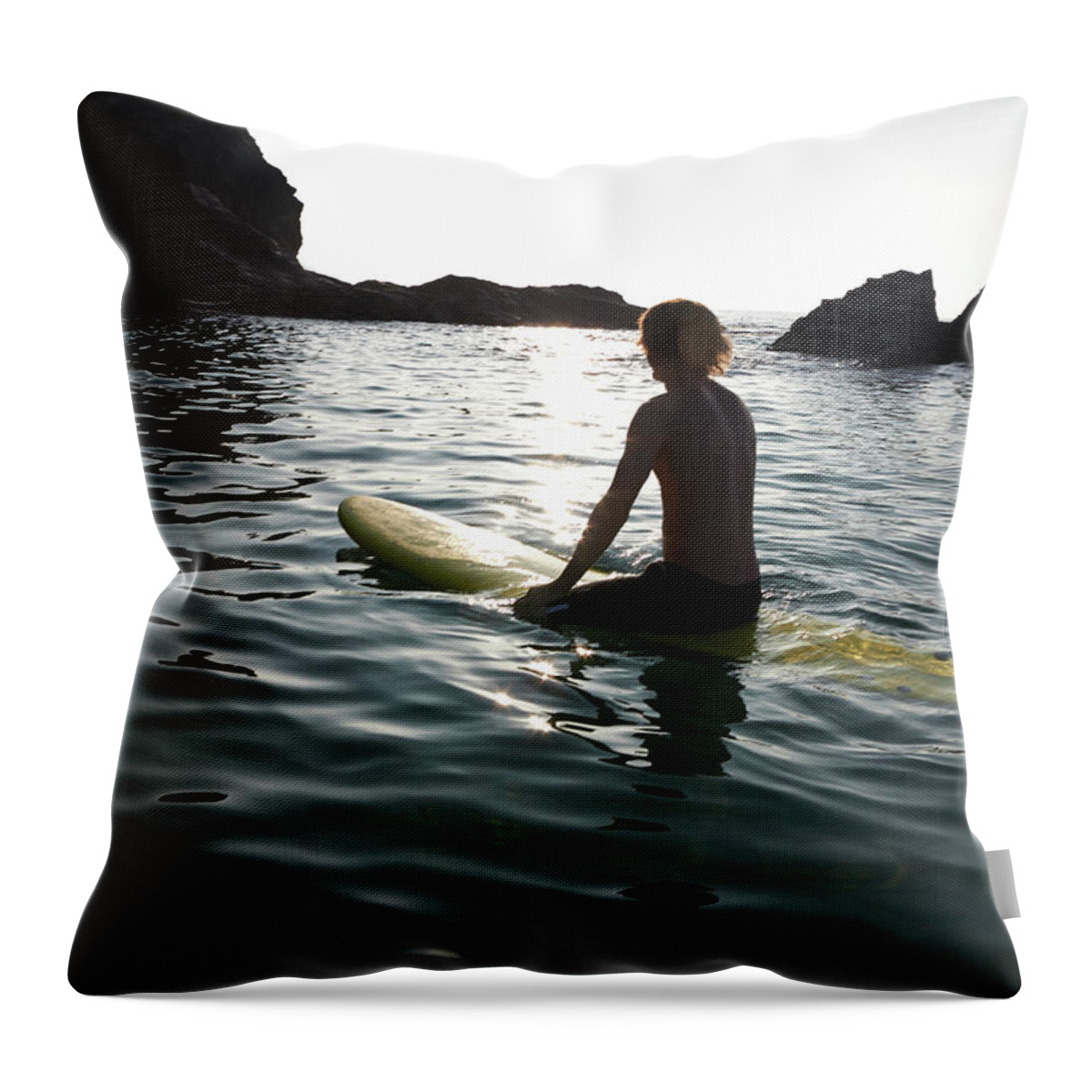 Tranquility Throw Pillow featuring the photograph Man Sitting On Surf Board In Sea by Dougal Waters