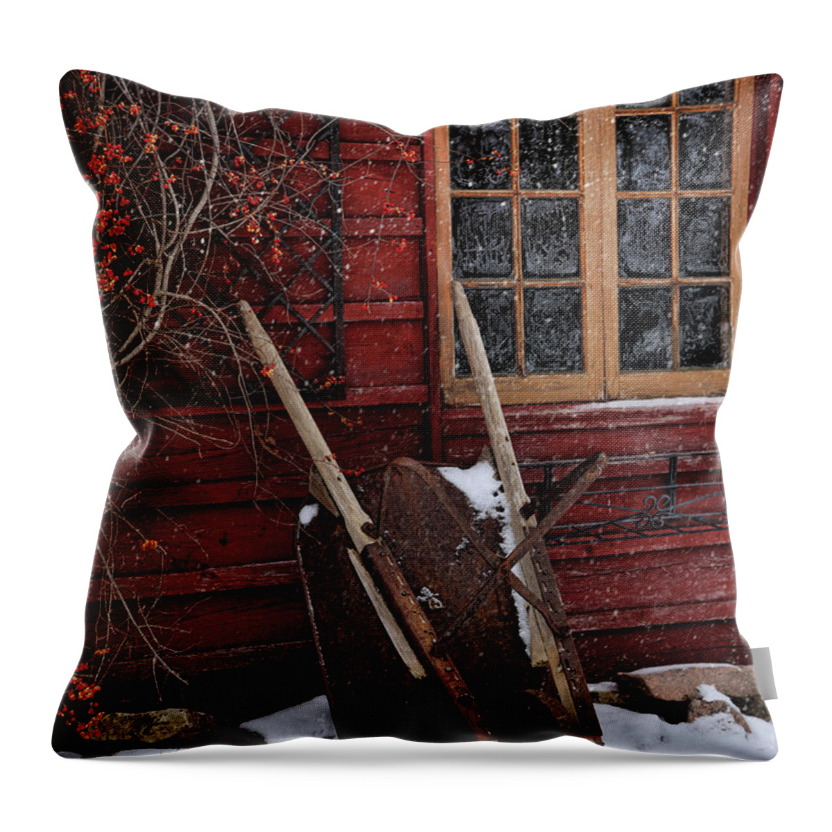 Atmosphere Throw Pillow featuring the photograph Old wheelbarrow leaning against barn in winter by Sandra Cunningham