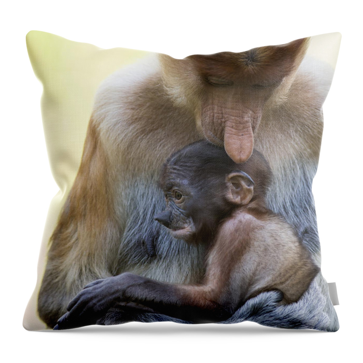 Suzi Eszterhas Throw Pillow featuring the photograph Proboscis Monkey Mother Holding Baby by Suzi Eszterhas