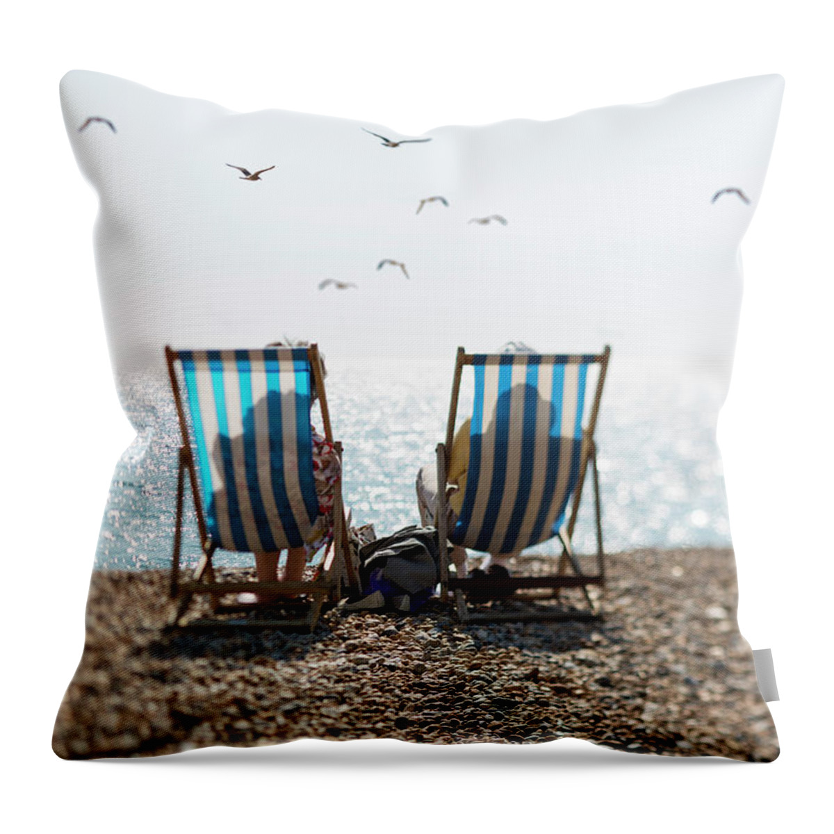 Tranquility Throw Pillow featuring the photograph Two People On Deckchairs And Seagulls by Richard Boll