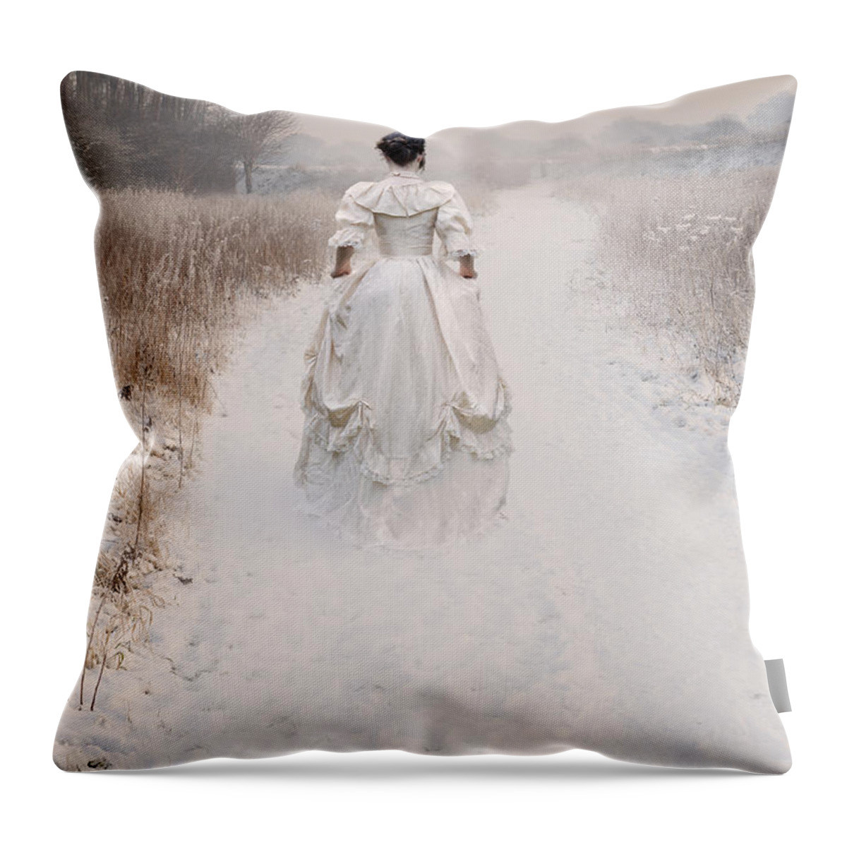 Woman Throw Pillow featuring the photograph Victorian Woman Walking Through A Winter Meadow by Lee Avison