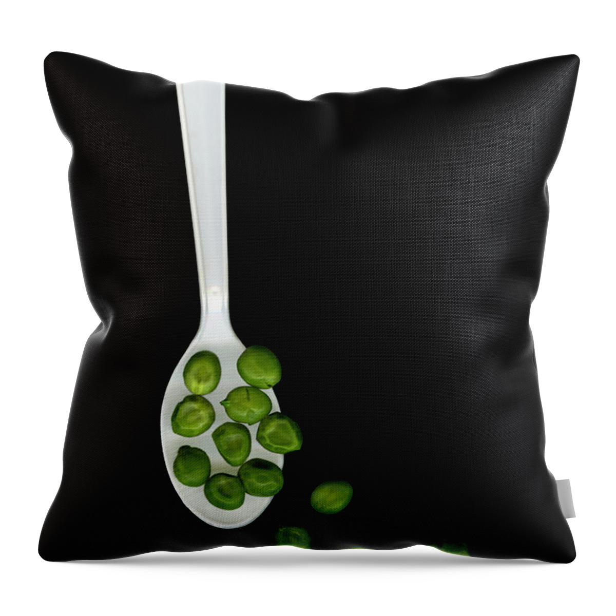 Black Background Throw Pillow featuring the photograph White Plastic Spoon And Green Peas by Thomas J Peterson