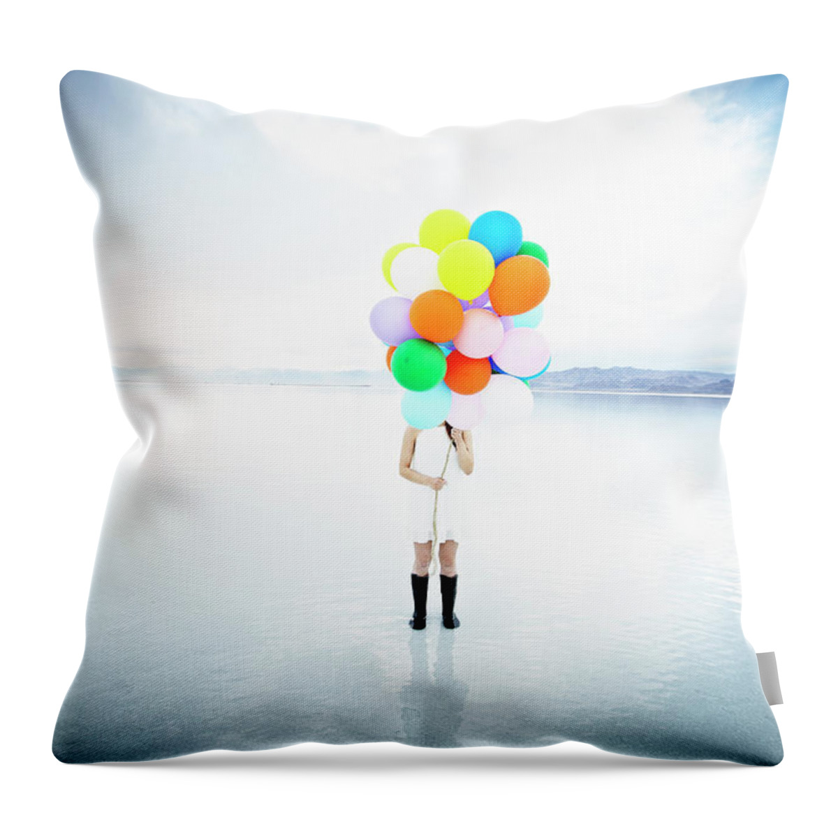 Scenics Throw Pillow featuring the photograph Woman In Water Standing Behind Balloons by Thomas Barwick