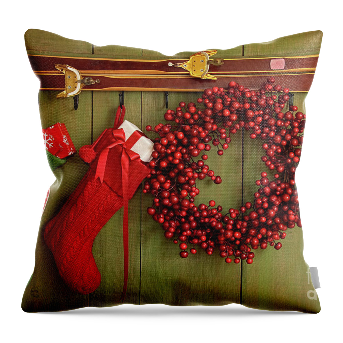 Antique Throw Pillow featuring the photograph Christmas stockings and wreath hanging on wall by Sandra Cunningham