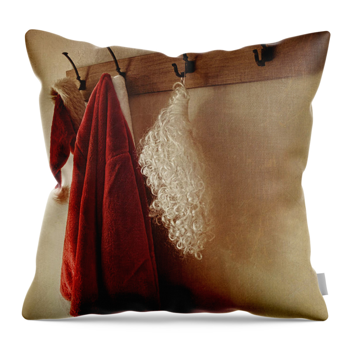 Background Throw Pillow featuring the photograph Santa costume hanging on coat rack by Sandra Cunningham