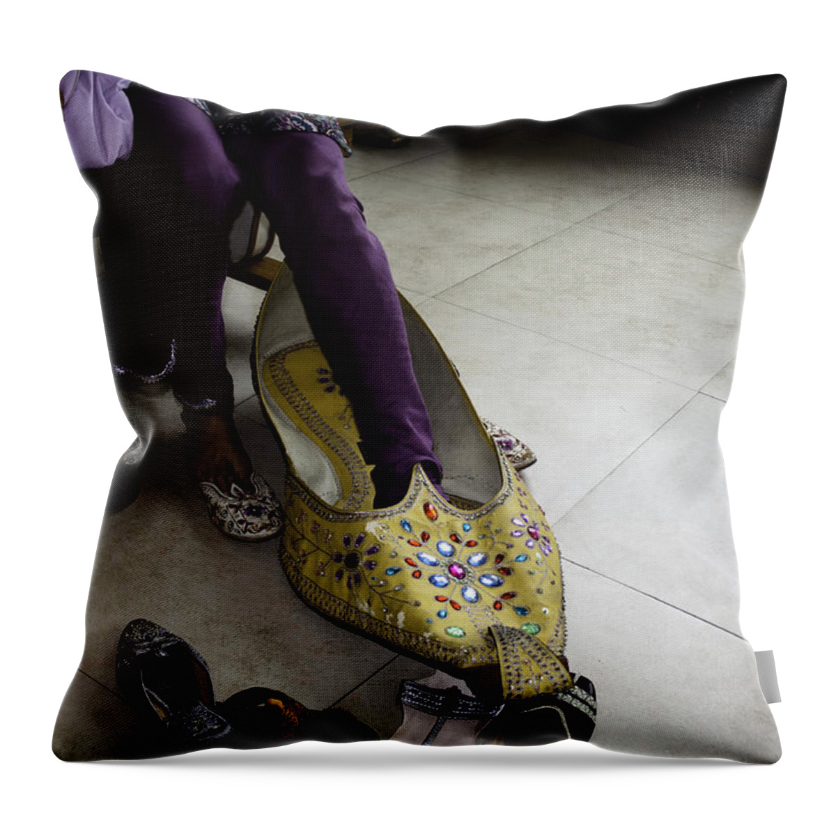 Amritsar Throw Pillow featuring the photograph Trying on a very large decorated shoe by Ashish Agarwal