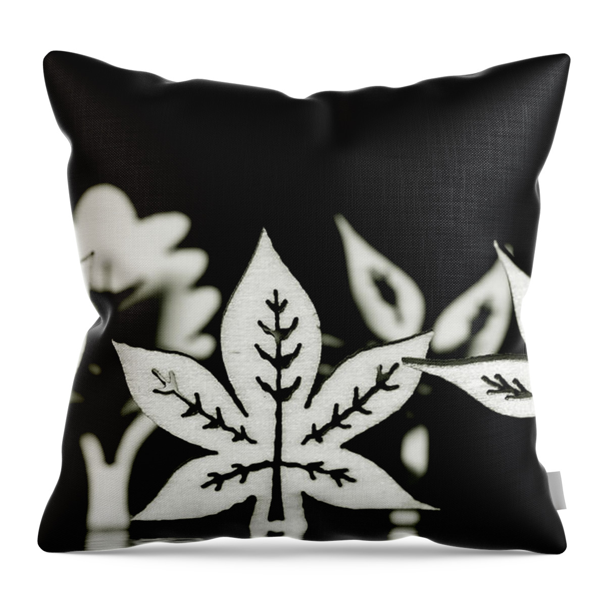 Leaf Throw Pillow featuring the photograph Wooden leaf shapes in black and white by Simon Bratt