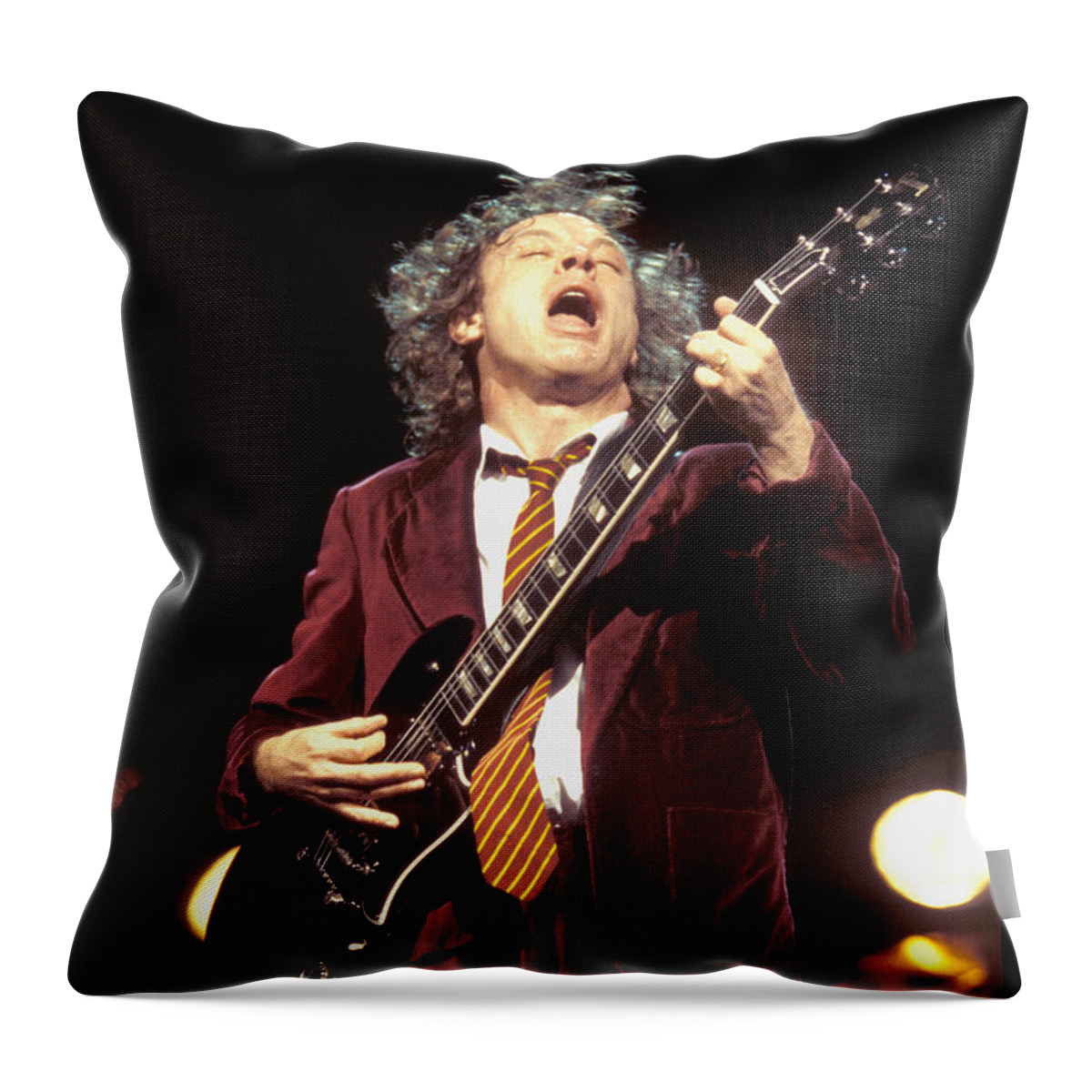 Ac/dc Guitarist Angus Young Is Shown Performing On Stage During A Live Concert Appearance Throw Pillow featuring the photograph Ac Dc - Angus Young #1 by Concert Photos