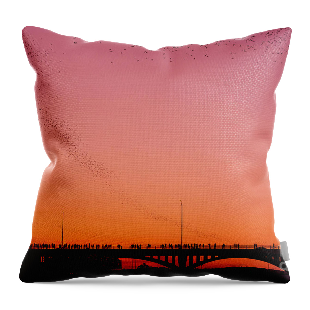 Mexican Free-tail Bats Throw Pillow featuring the photograph Amazing image of Austins Mexican free-tailed bats take flight during a spectacular pink sunset by Dan Herron