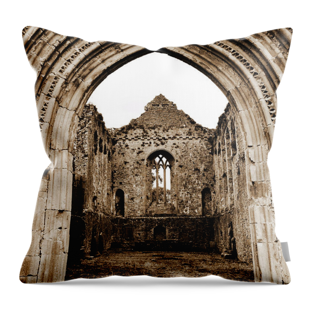 Athassel Throw Pillow featuring the photograph Athassel Priory Tipperary Ireland Medieval Ruins Decorative Arched Doorway Into Great Hall Sepia by Shawn O'Brien