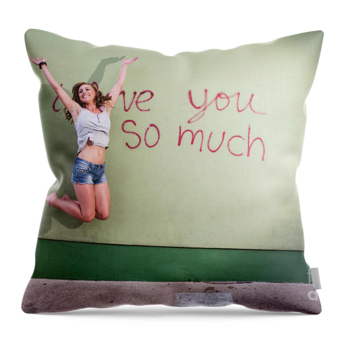 I Love You So Much Throw Pillow featuring the photograph Attractive Austin local woman jumps for joy at the i love you so much mural by Dan Herron
