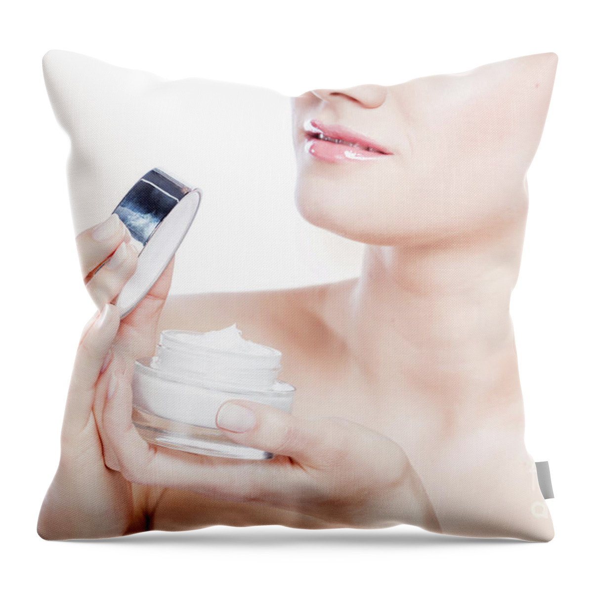 Skincare Throw Pillow featuring the photograph Attractive woman opening a face cream. by Michal Bednarek