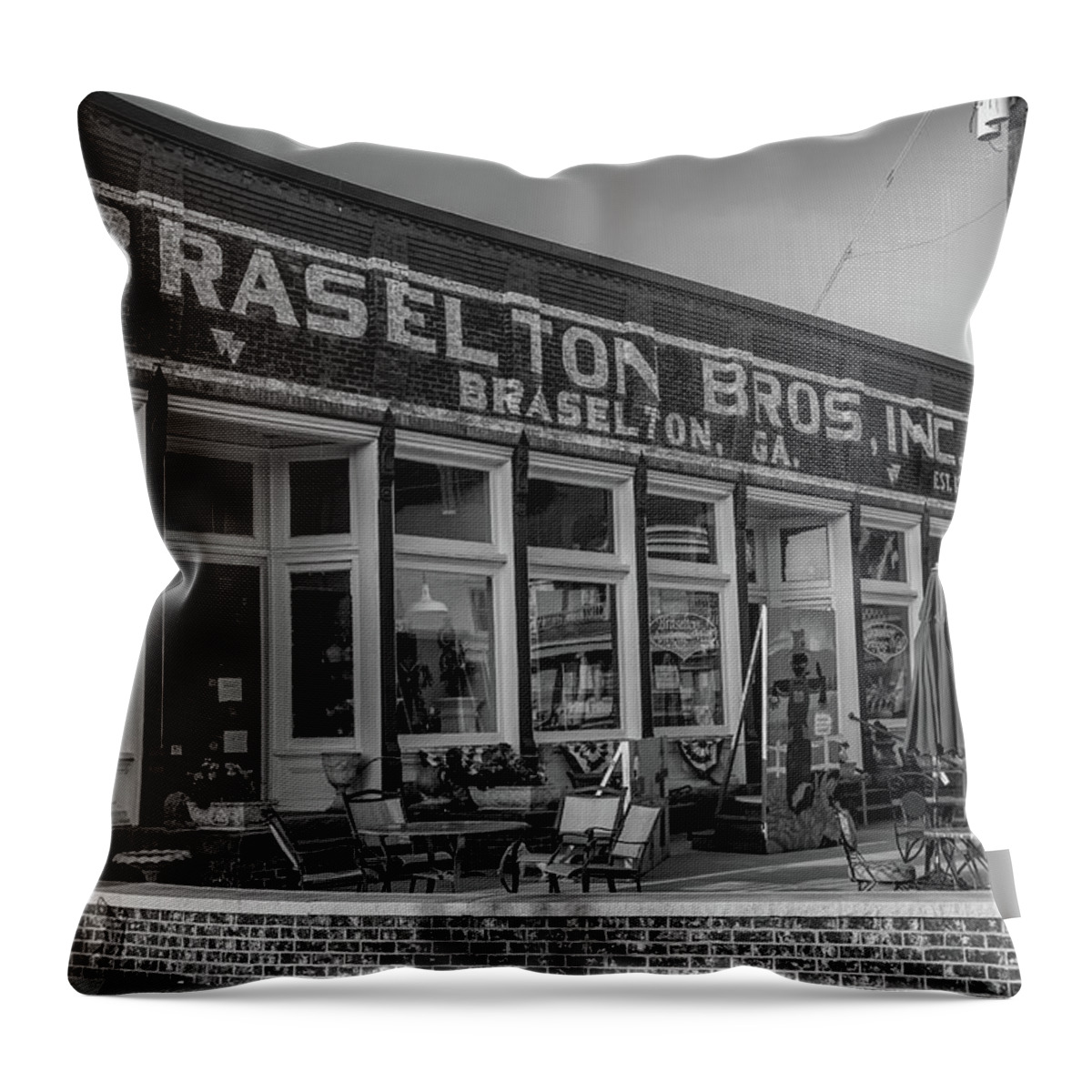 Braselton Throw Pillow featuring the photograph Braselton Bros Inc. Store Front in BW by Doug Camara