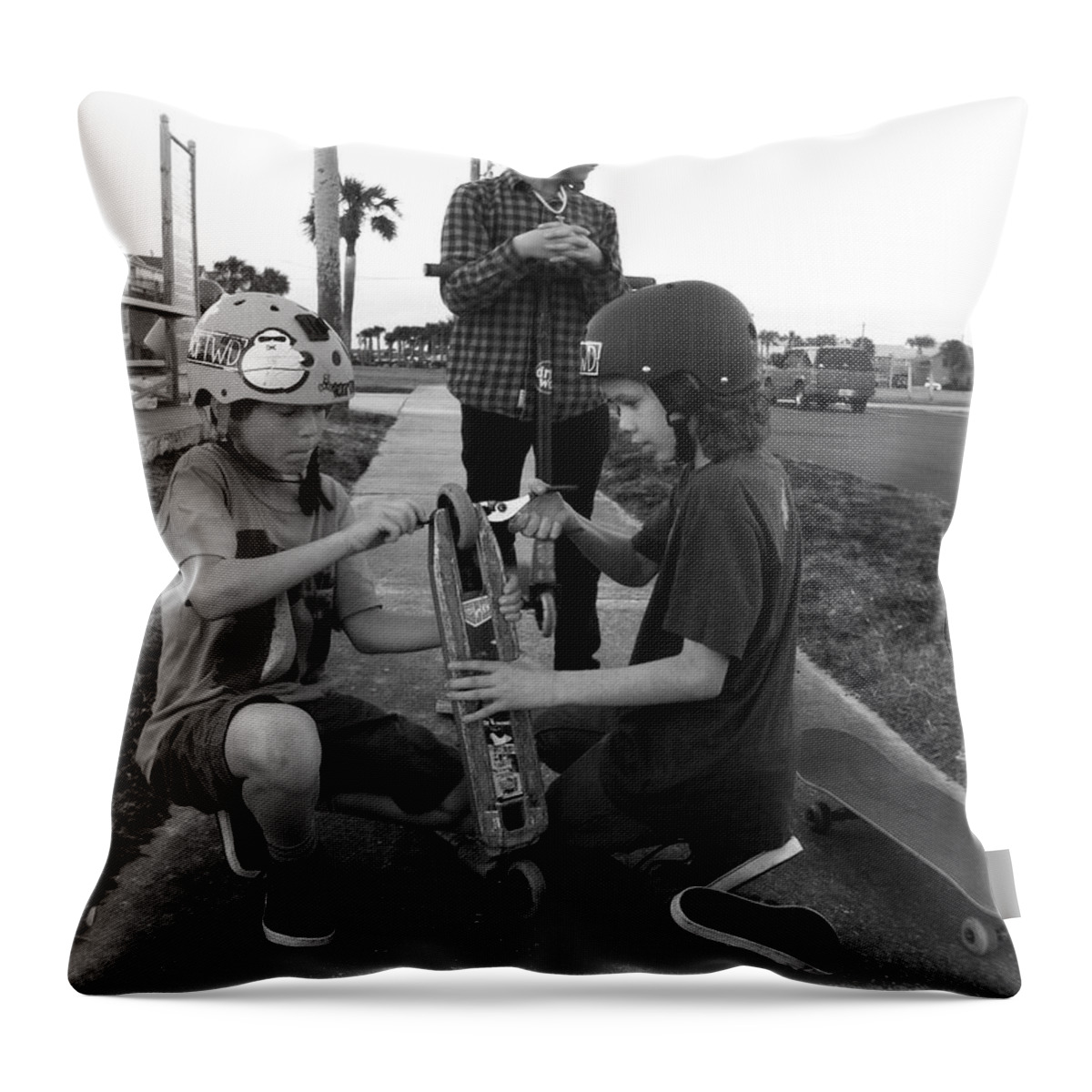 Skateboard Throw Pillow featuring the photograph Fixing a skooter by WaLdEmAr BoRrErO