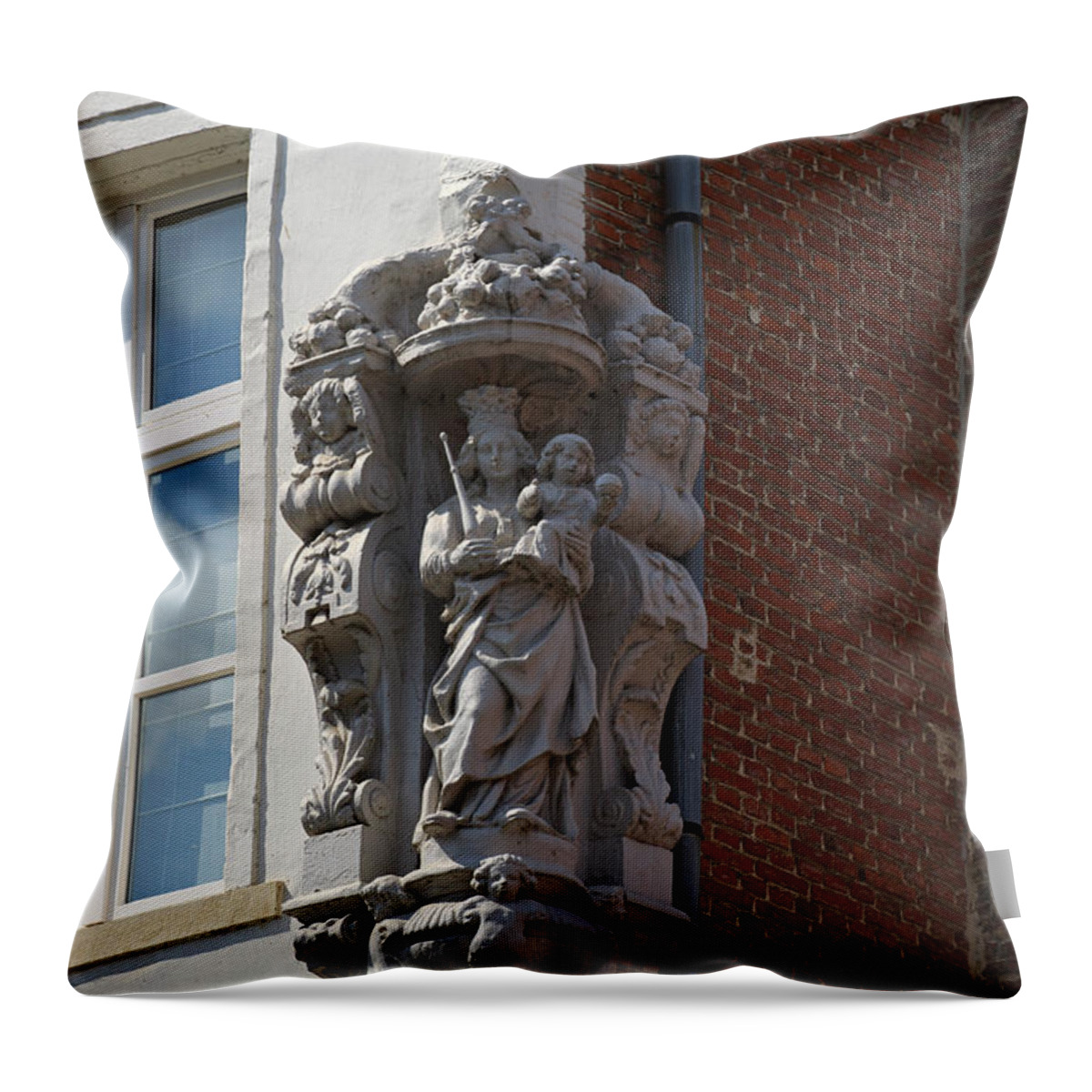 Madonna Throw Pillow featuring the photograph Madonna and Child Statue on the Corner of a House in Bruges by Louise Heusinkveld