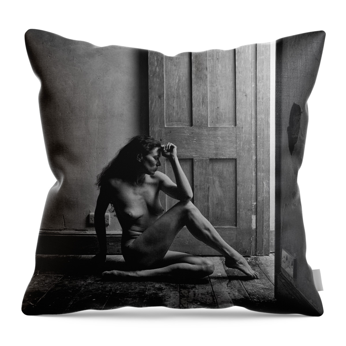 Woman Throw Pillow featuring the photograph Nude woman sitting by doorway in abandoned room by Clayton Bastiani