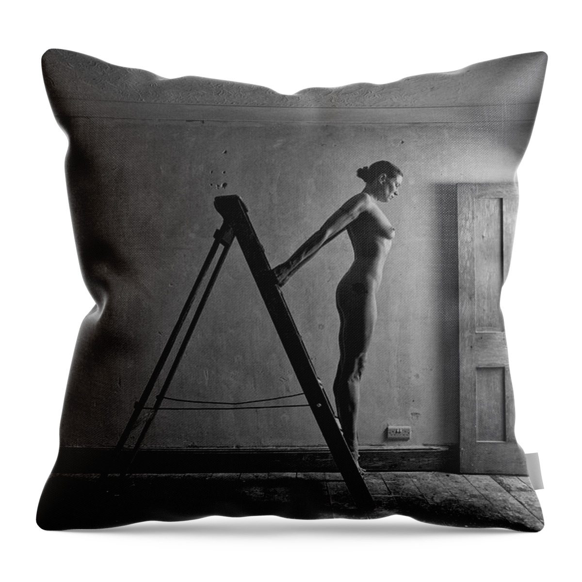 Woman Throw Pillow featuring the photograph Nude woman standing on ladder by Clayton Bastiani