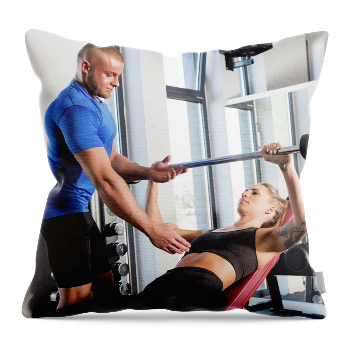 Gym Throw Pillow featuring the photograph Personal trainer working with a client at the gym. by Michal Bednarek