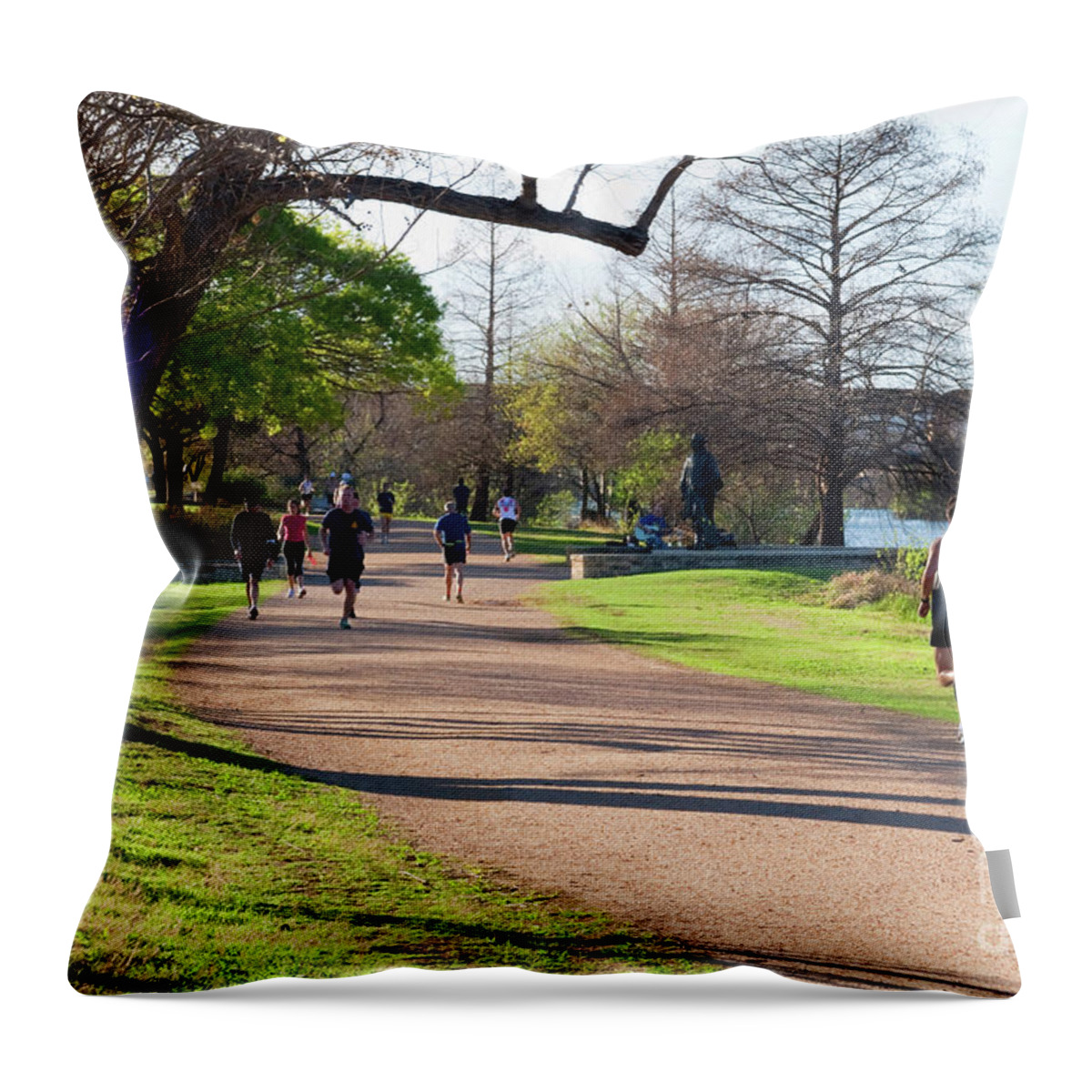 Stevie Ray Vaughan Statue Throw Pillow featuring the photograph Runners and joggers on the hike and bike trail town lake Austin Texas by Dan Herron