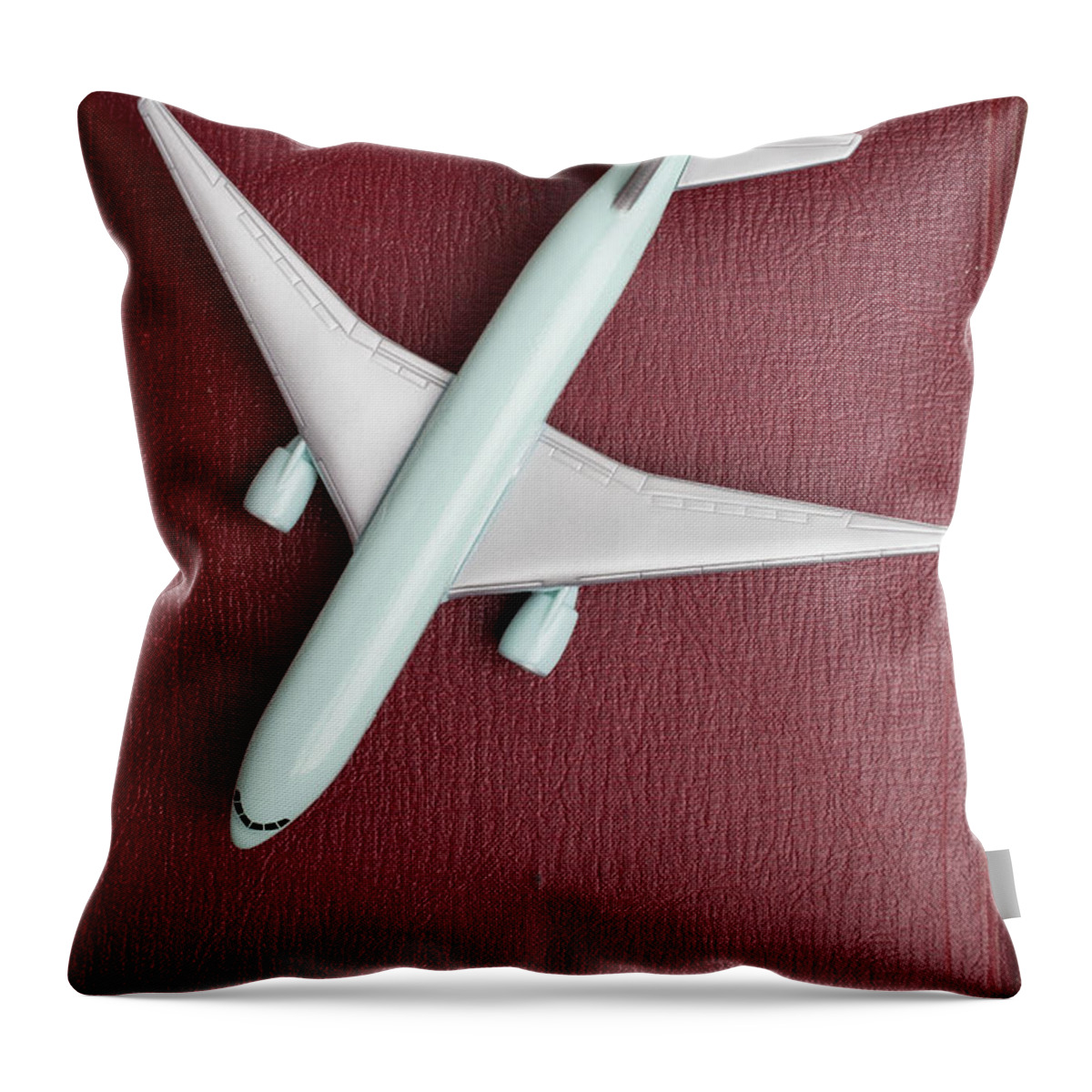 Still Life Throw Pillow featuring the photograph Toy Airplane over Red Book Cover by Edward Fielding