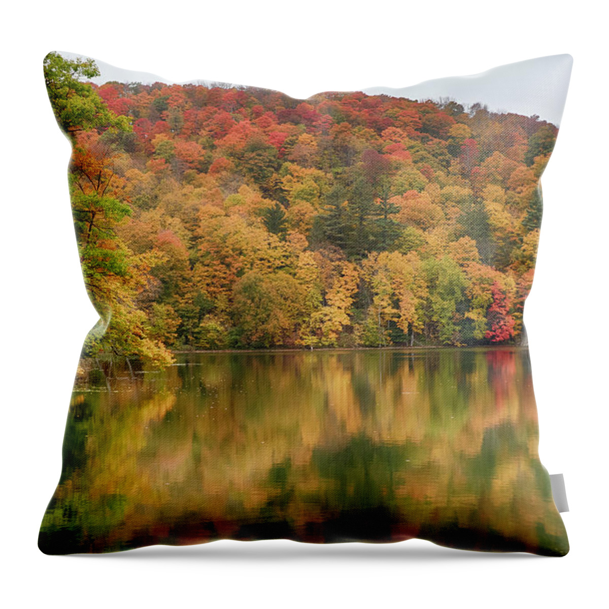 Abenaki Throw Pillow featuring the photograph Vermont fall foliage reflected on Pogue Pond by Jeff Folger