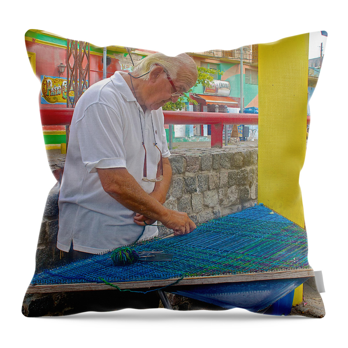 Weaver In La Boca Barrio In Buenos Aires Throw Pillow featuring the photograph Weaver in La Boca Area of Buenos Aires-Argentina  by Ruth Hager