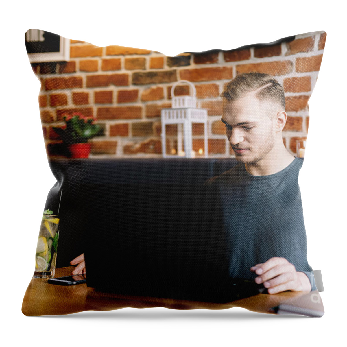 Man Throw Pillow featuring the photograph Young man working in a restaurant. Freelance job. by Michal Bednarek
