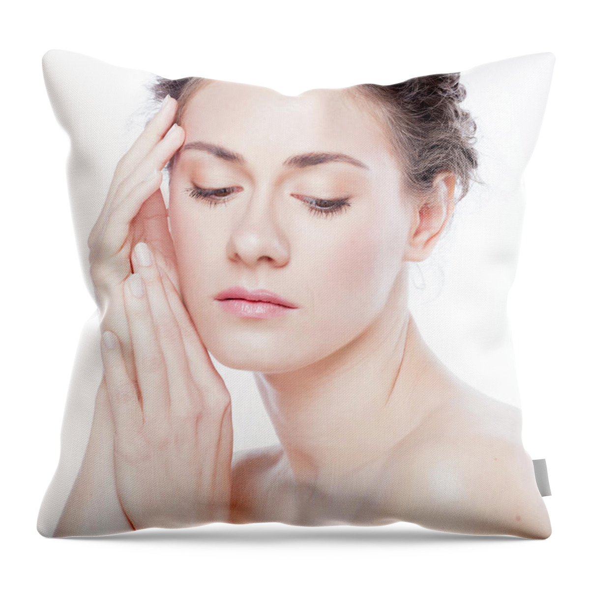 Skincare Throw Pillow featuring the photograph Young woman touching her skin. by Michal Bednarek
