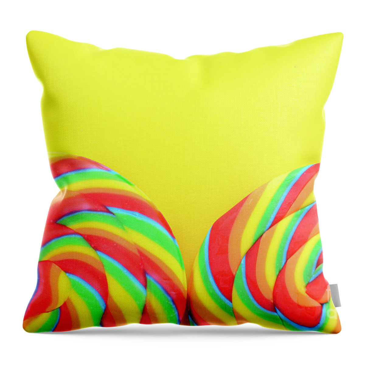 Holiday Throw Pillow featuring the photograph Rainbow lollipop candy on bright yellow wood table. #2 by Milleflore Images