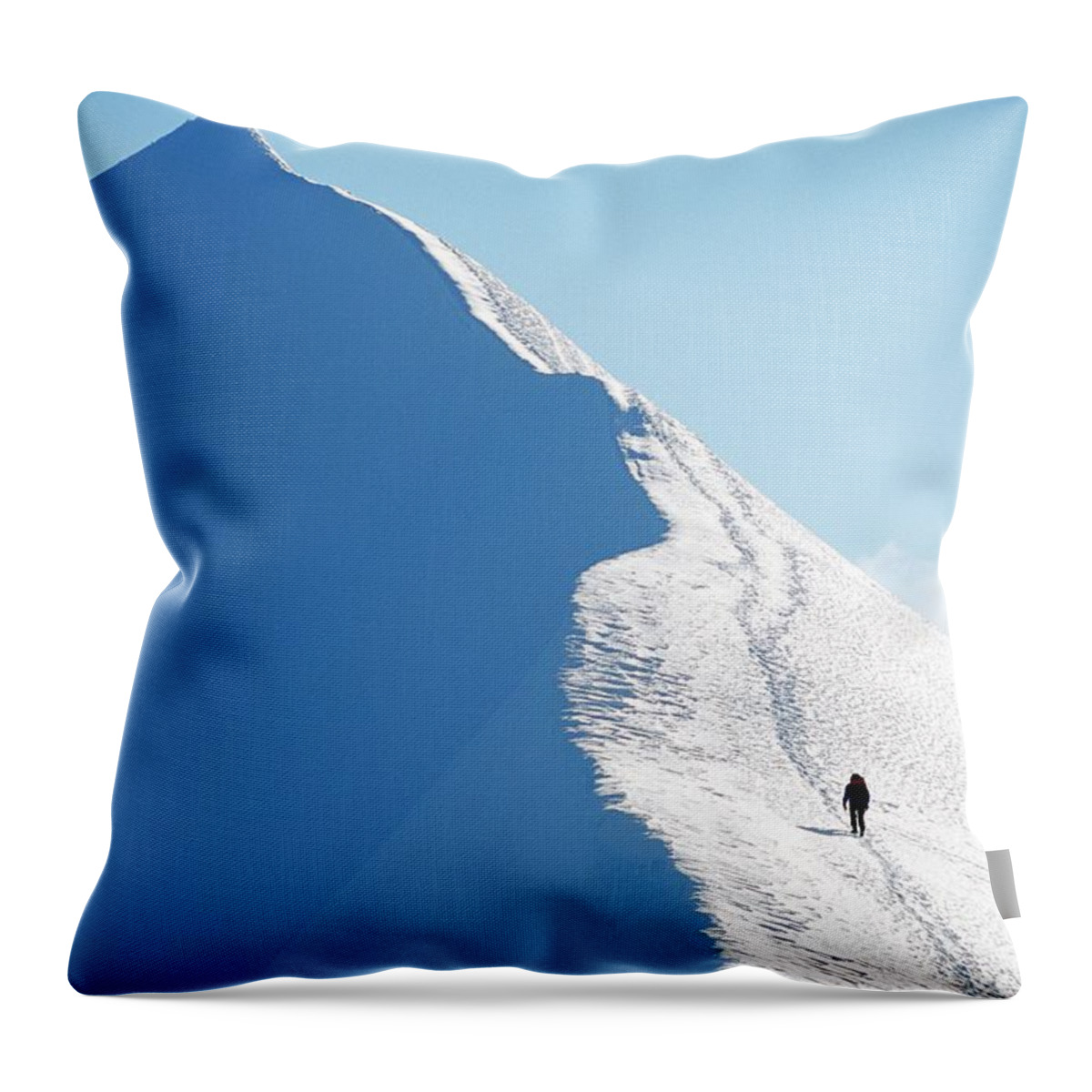 Snow Throw Pillow featuring the photograph A Person Hiking On A Mountain Peak by Hakan Hjort