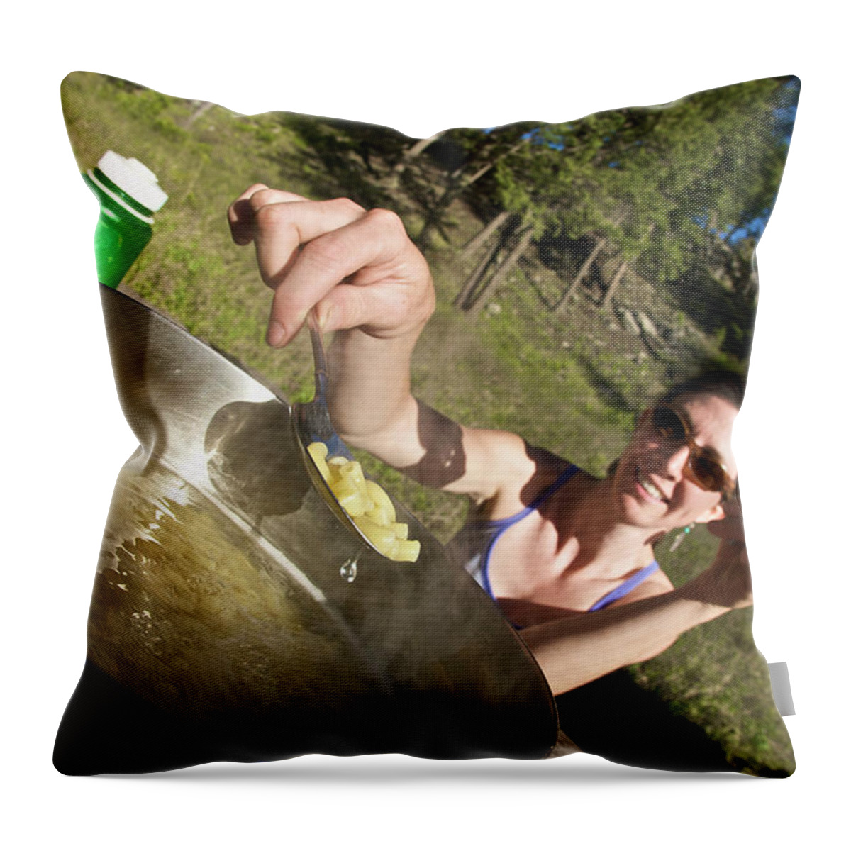 Camping Throw Pillow featuring the photograph A Young Woman Cooks Her Macaroni Dinner by Derek Diluzio