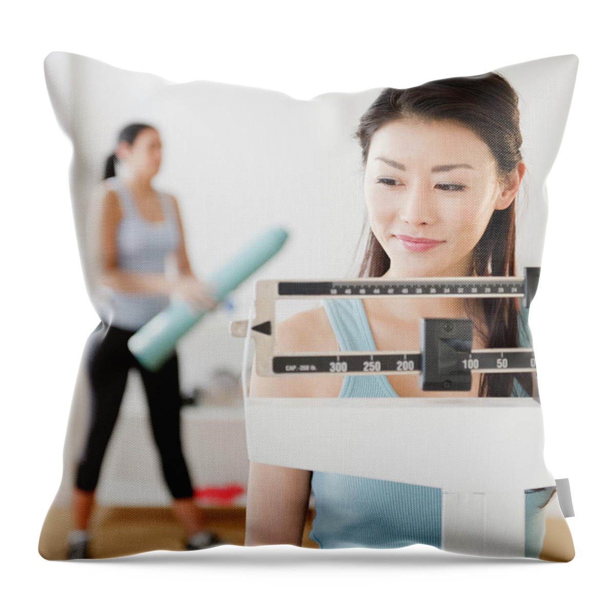 Asian And Indian Ethnicities Throw Pillow featuring the photograph Asian Woman Weighing Herself On Scale by Jgi/jamie Grill
