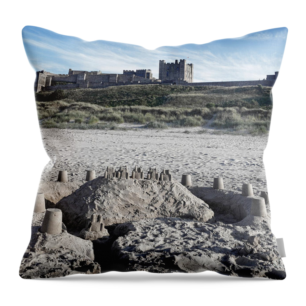 Bamburgh Castle Throw Pillow featuring the photograph Bamburgh Castle and beach. by David Birchall