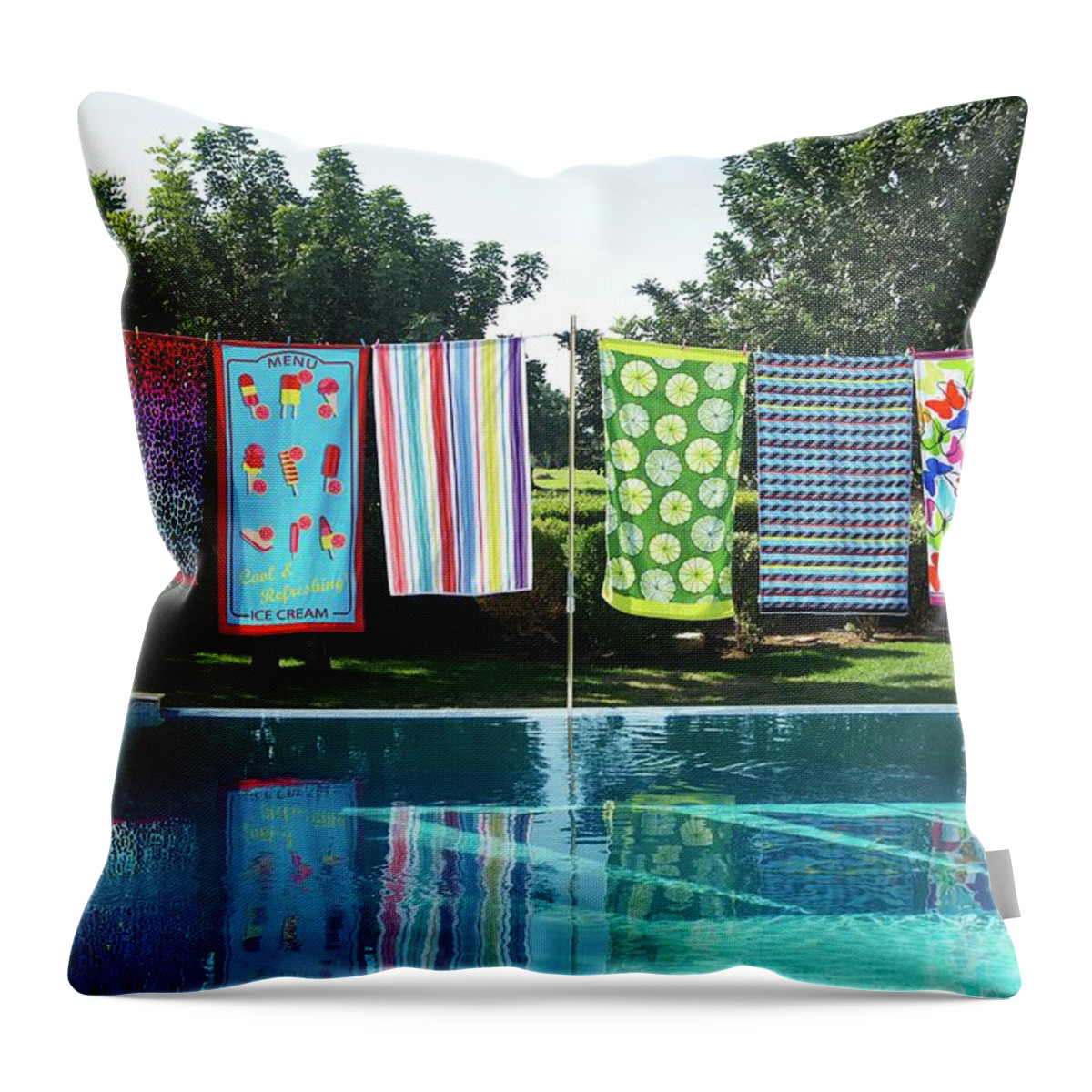 Ip_11244046 Throw Pillow featuring the photograph Colourful Patterned Towels On Washing Line On Edge Of Pool In Garden by Winfried Heinze