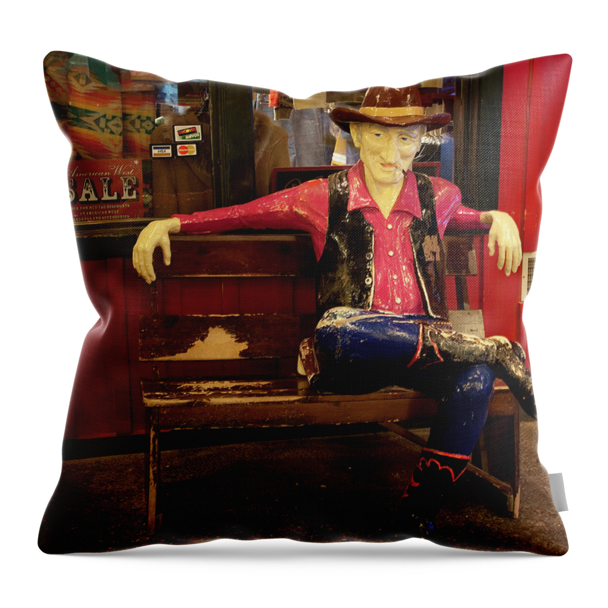 Wall Throw Pillow featuring the painting Cowboy sits on bench at Wall Drug in South Dakota by 