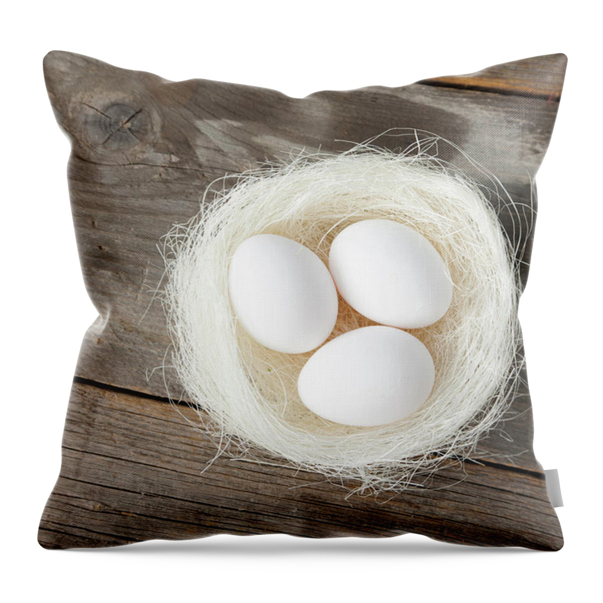 Bavaria Throw Pillow featuring the photograph Eggs In Nest On Wooden Counter by Stefanie Grewel