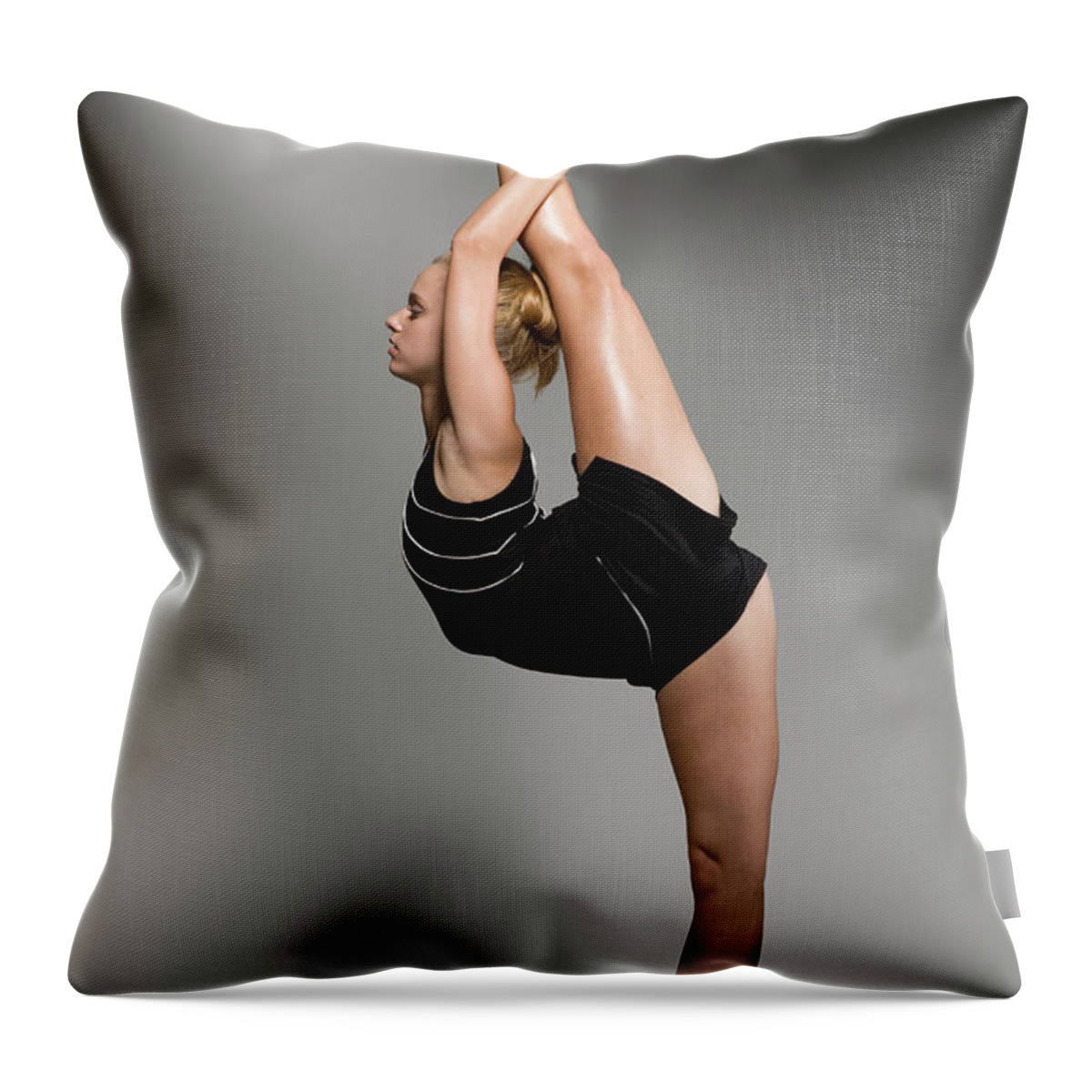Human Arm Throw Pillow featuring the photograph Female Gymnast Stretching, Studio Shot by Siri Stafford
