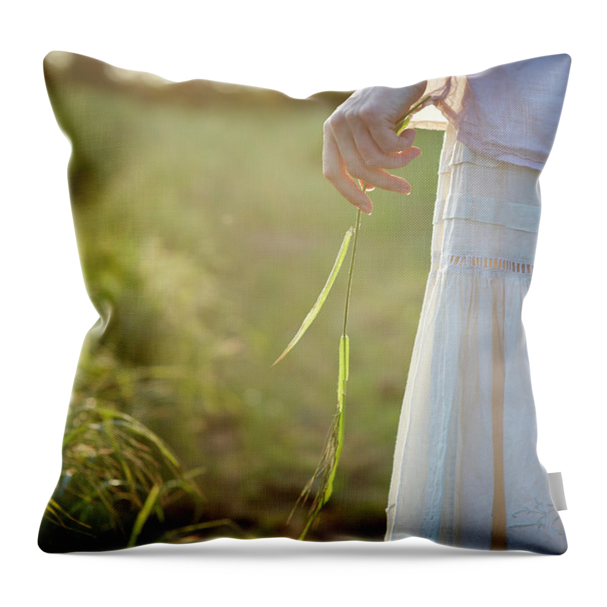 Grass Throw Pillow featuring the photograph Female Hand Holding Grass In by Dougal Waters