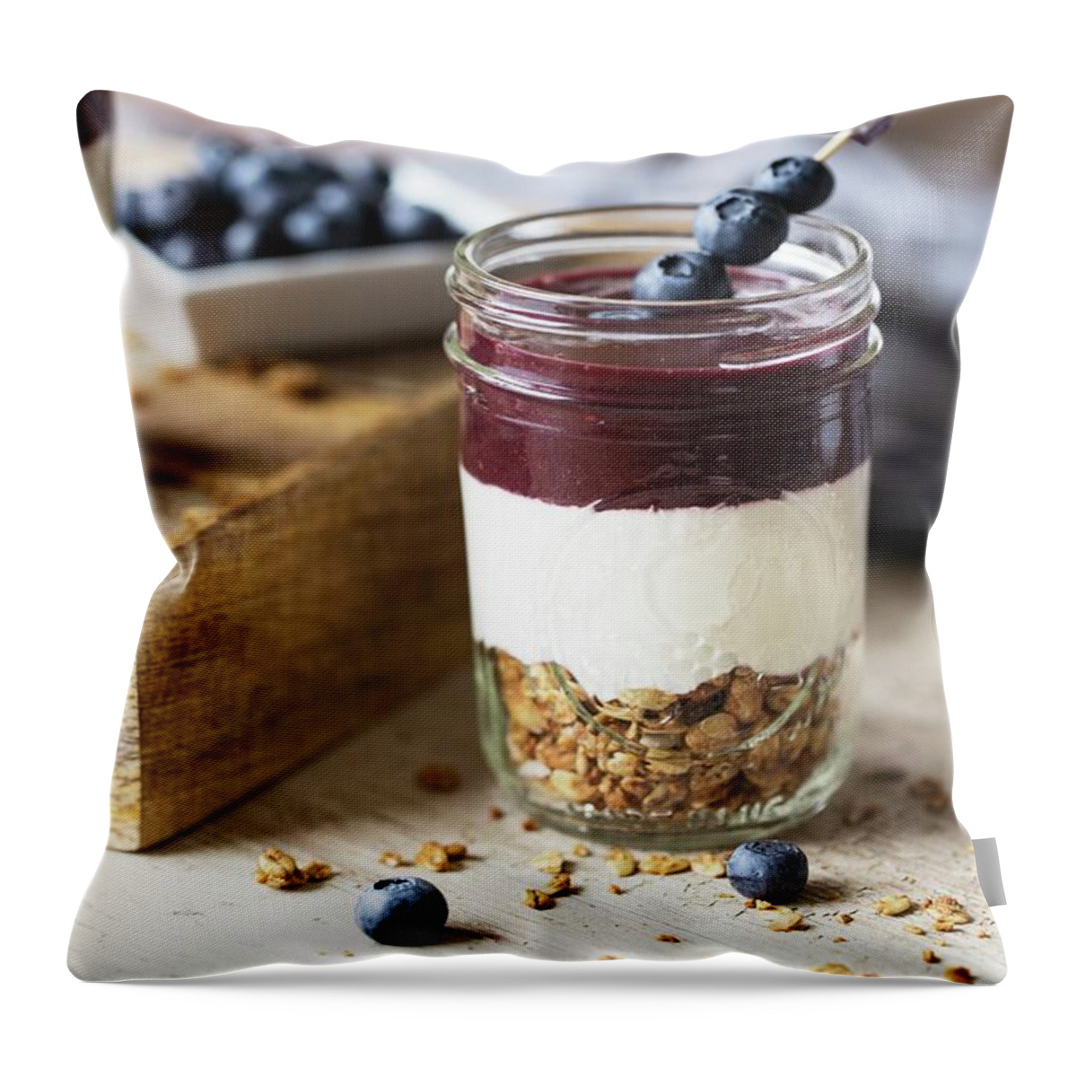 Ip_12316071 Throw Pillow featuring the photograph Layered Granola, Yoghurt And Acai Puree, Garnished With Blueberries by Nicole Godt