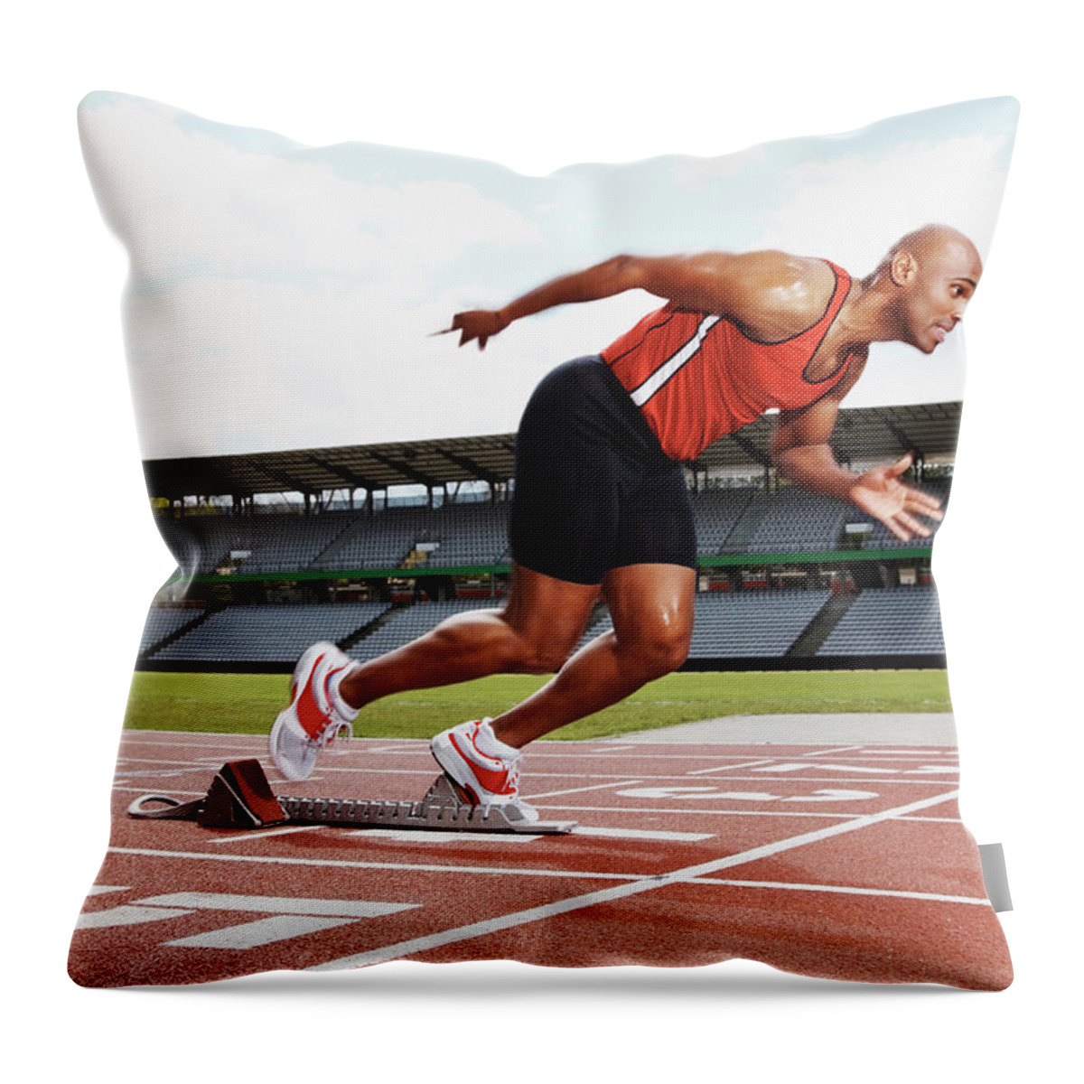 Expertise Throw Pillow featuring the photograph Male Athlete On The Starting Line Of by Globalstock