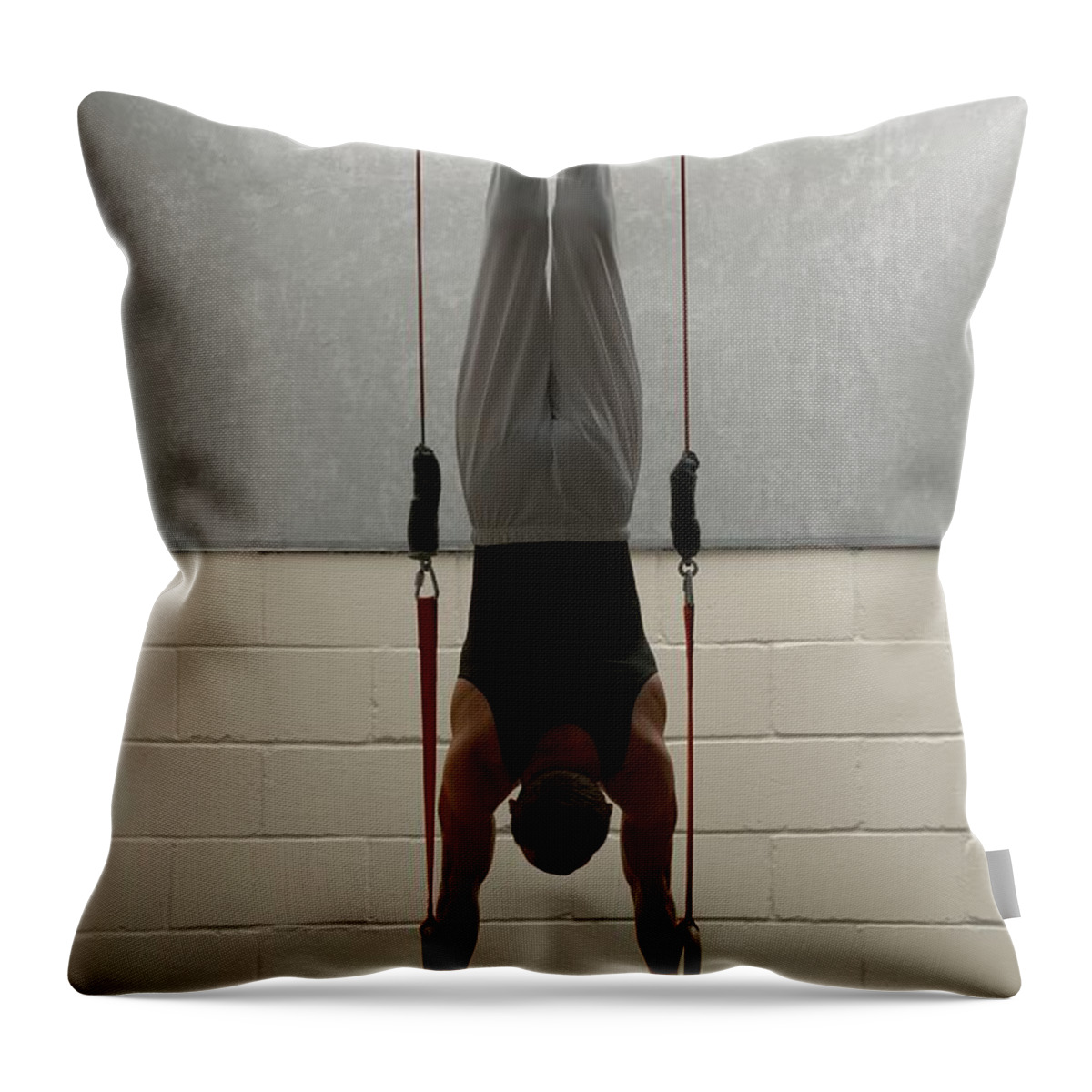 Hanging Throw Pillow featuring the photograph Male Gymnast Balancing Upside Down On by Romilly Lockyer