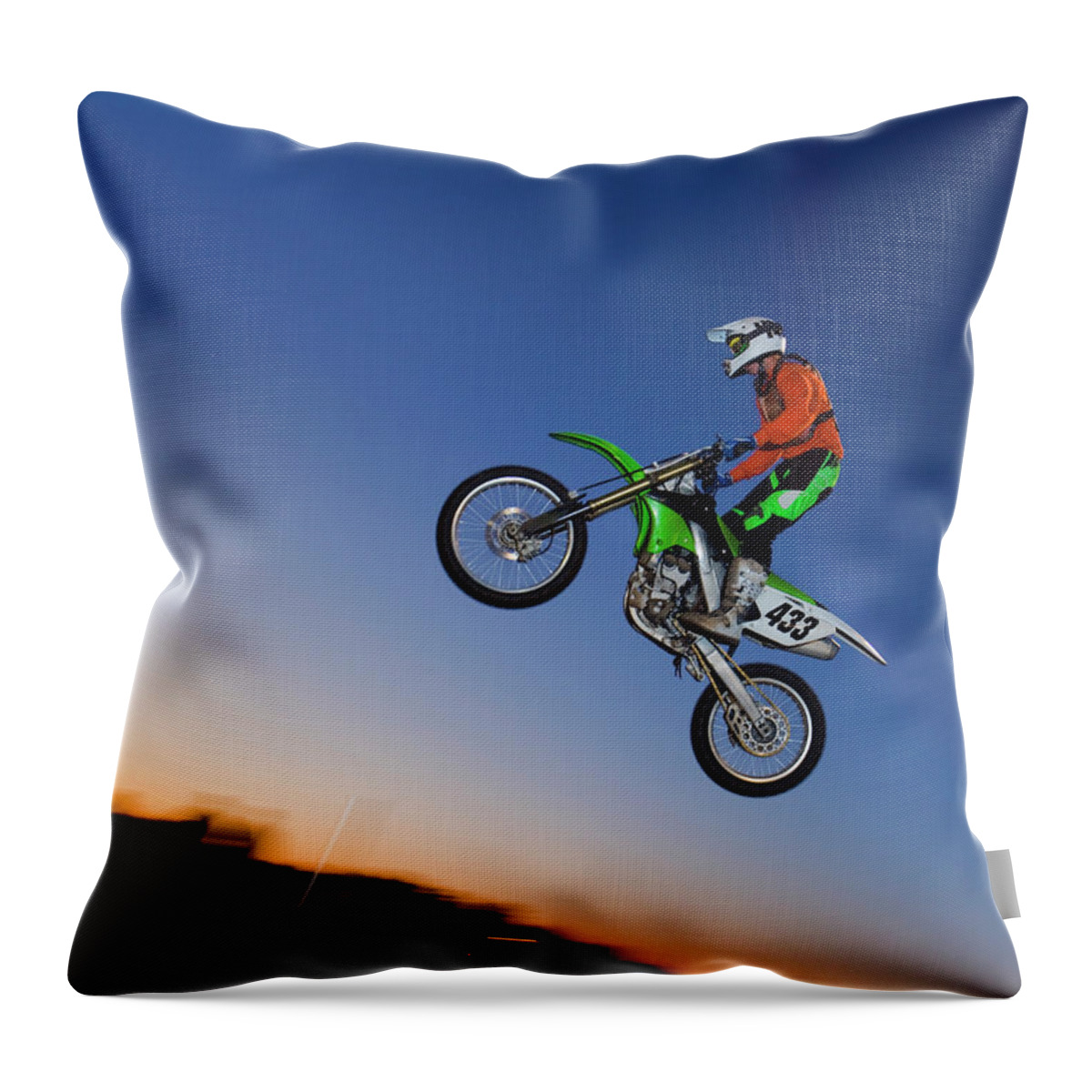 Dawn Throw Pillow featuring the photograph Motorcross Rider Jumping Dirt Bike by Jupiterimages
