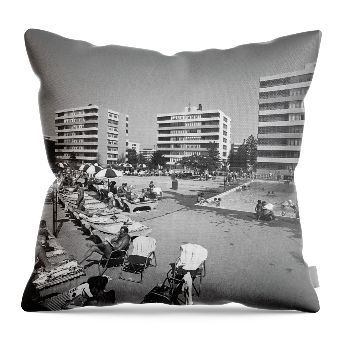 Apartment Throw Pillow featuring the photograph People Relaxing At Swimming Pool by George Marks