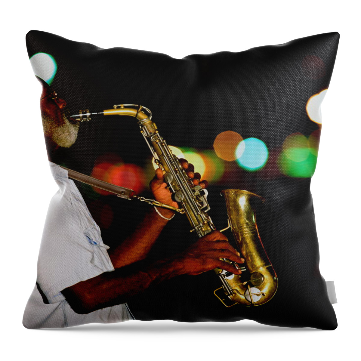 One Man Only Throw Pillow featuring the photograph Saxophonist On Street At Night, New by Siegfried Layda