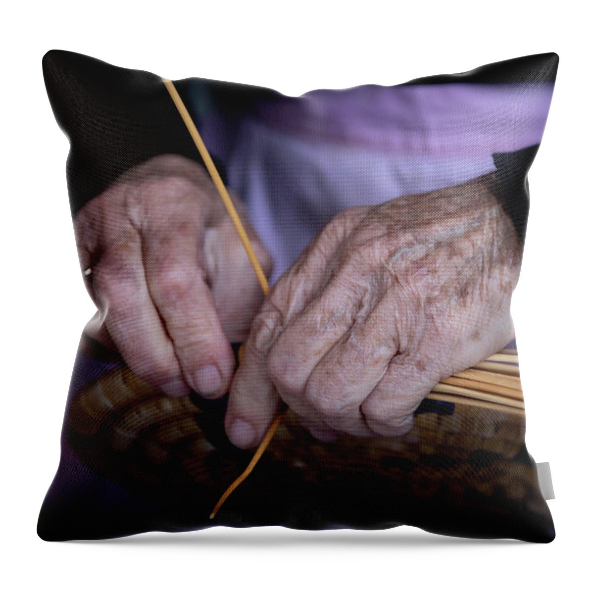 Knitting Throw Pillow featuring the photograph Senior woman knitting a traditional basket with reeds  by Michalakis Ppalis