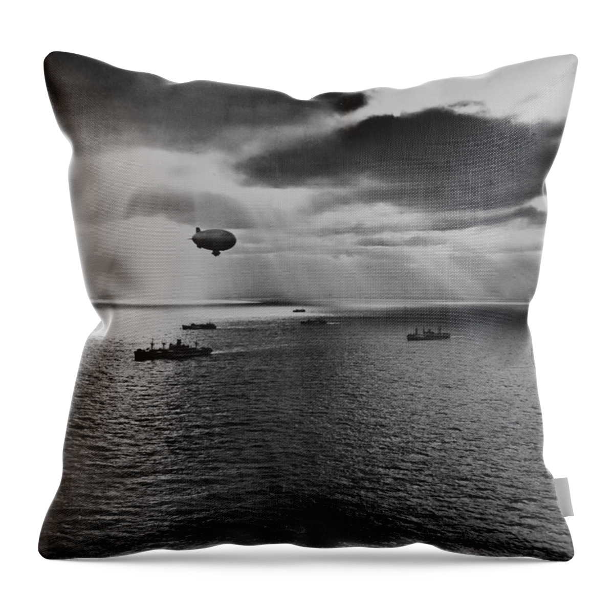 Sunset Throw Pillow featuring the painting Sunset over the Atlantic finds another United Nations convoy moving peacefully towards it destination. A U.S. Navy blimp, hovering watchfully overhead, is on the lookout for any sign of enemy submarines by 